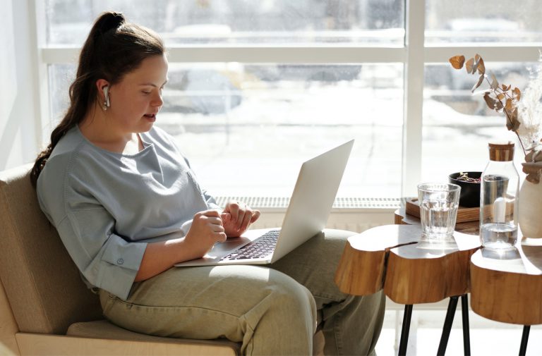 A woman with down syndrome working on her computer